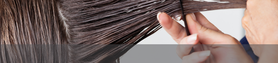 Image of combing hair with personal care additives and specialty surfactants.